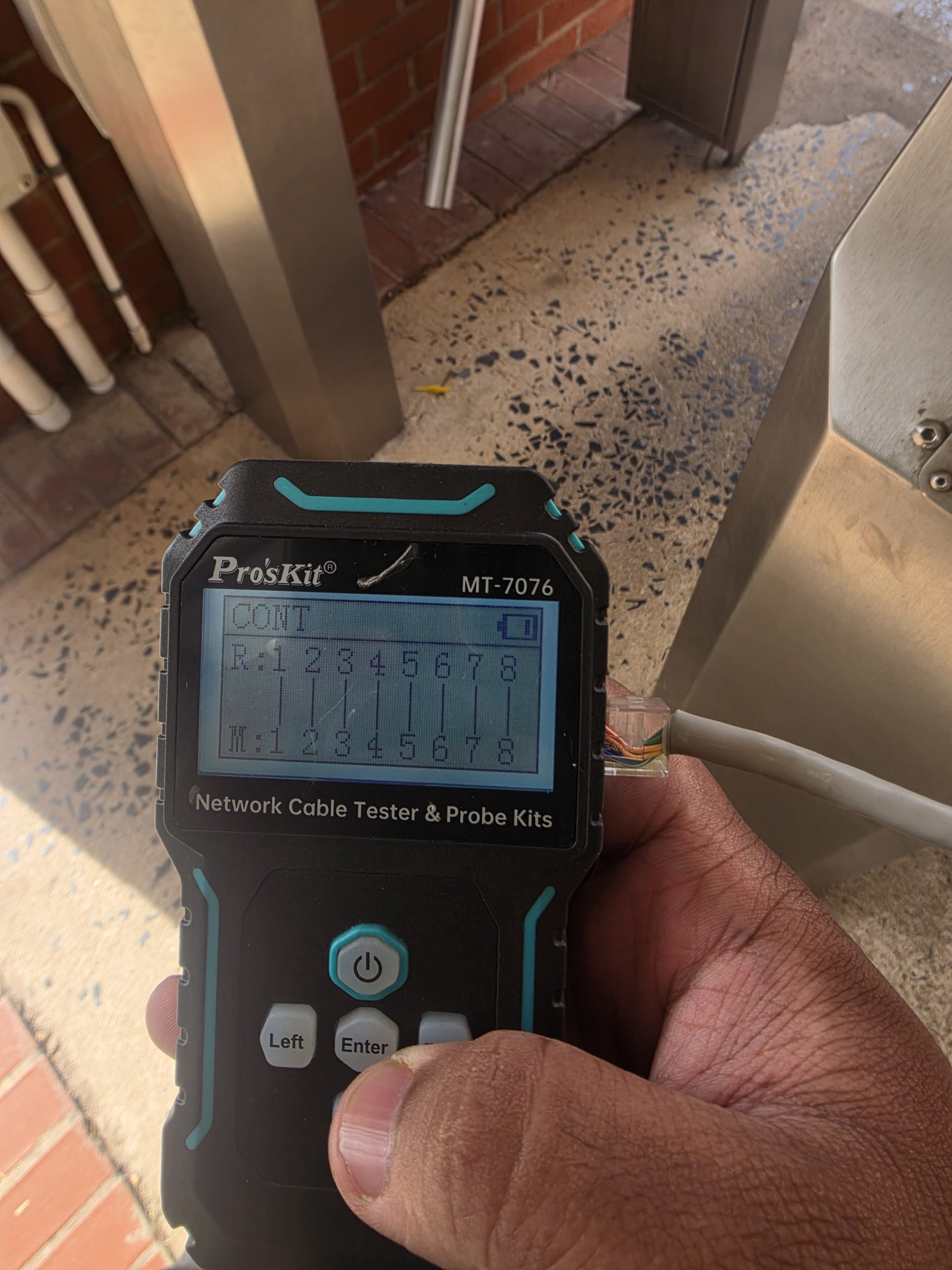 Handheld cable tester checking network cabling