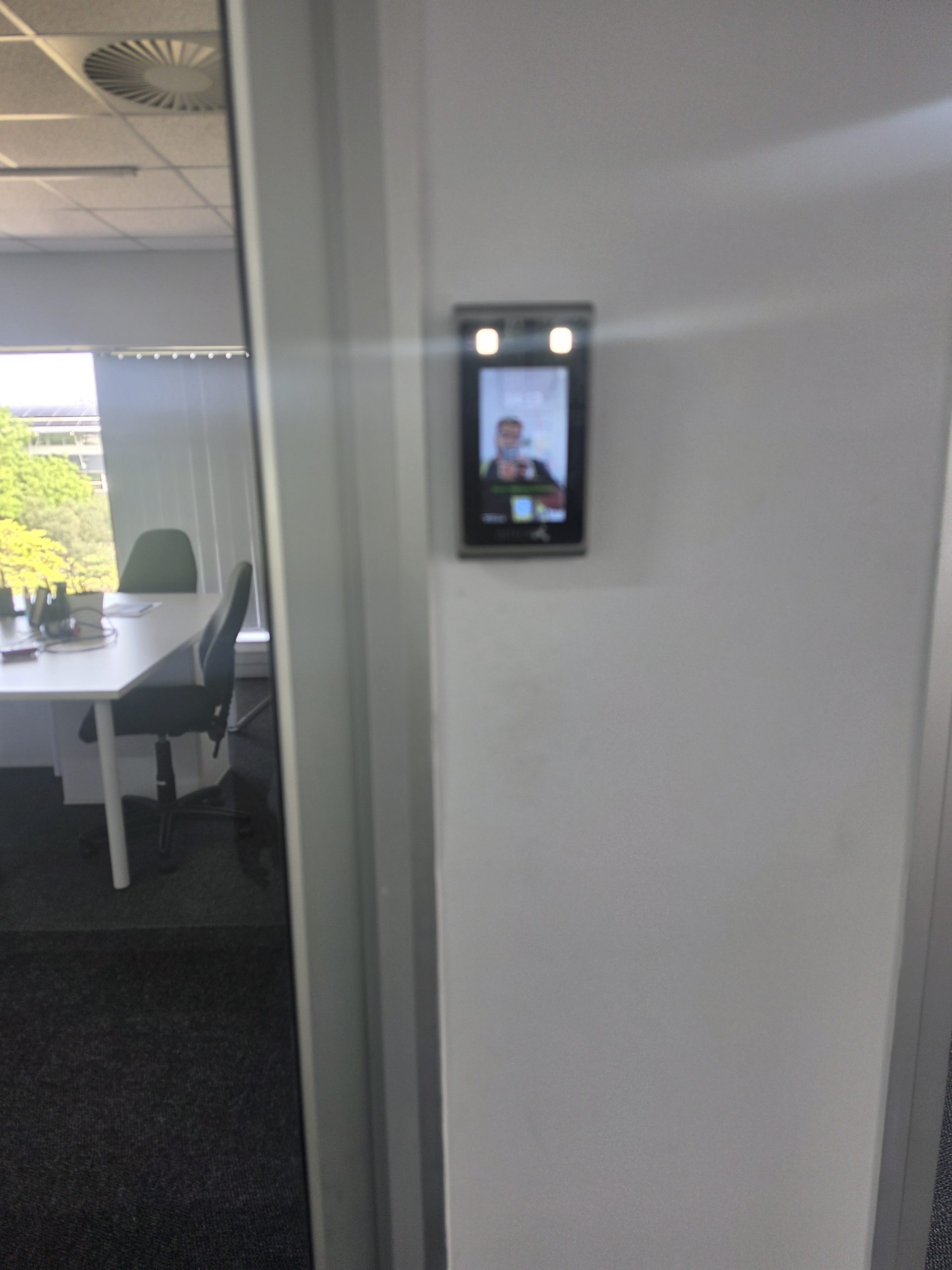 Access control reader installed beside an office entrance