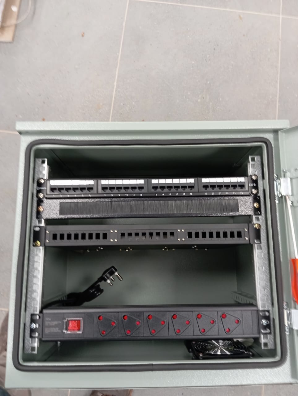Patch panels and rack mounted power distribution inside an equipment cabinet