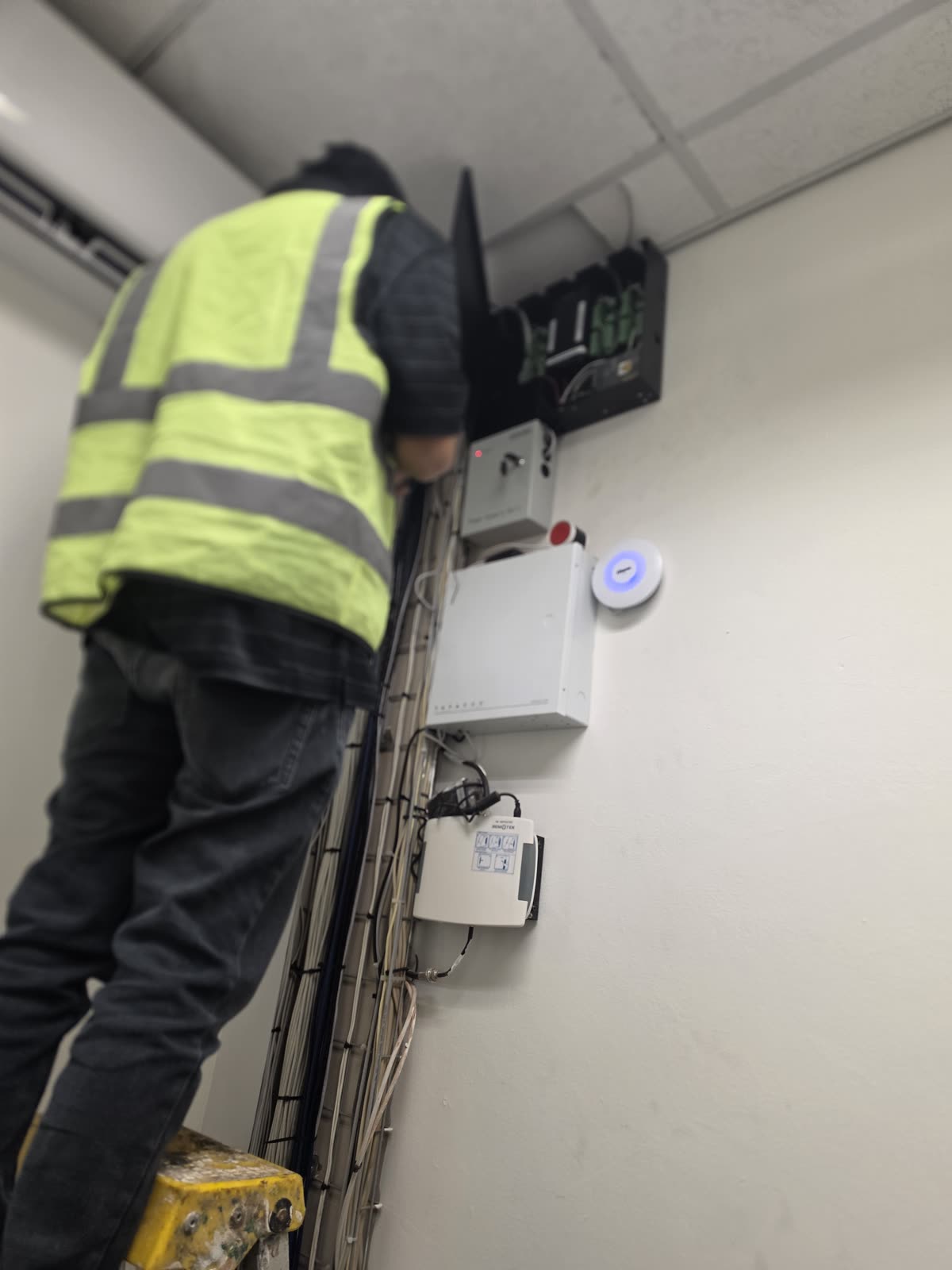 Technician working beside a wireless access point